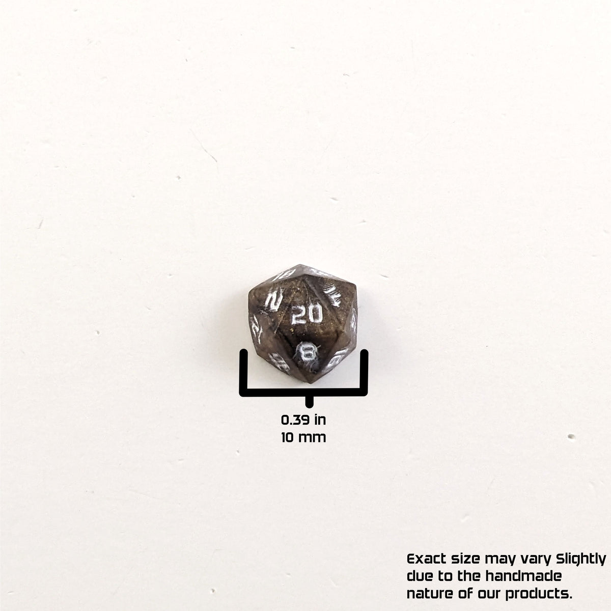 A size graphic of the d20 stud. The stud is brown with white numbers and centers the 20 face on a white background. The graphic overlay shows the width of the stud as 10 mm or 0.39 in. The lower righthand corner has a disclaimer that reads, "Exact size may vary slightly due to the handmade nature of our products."