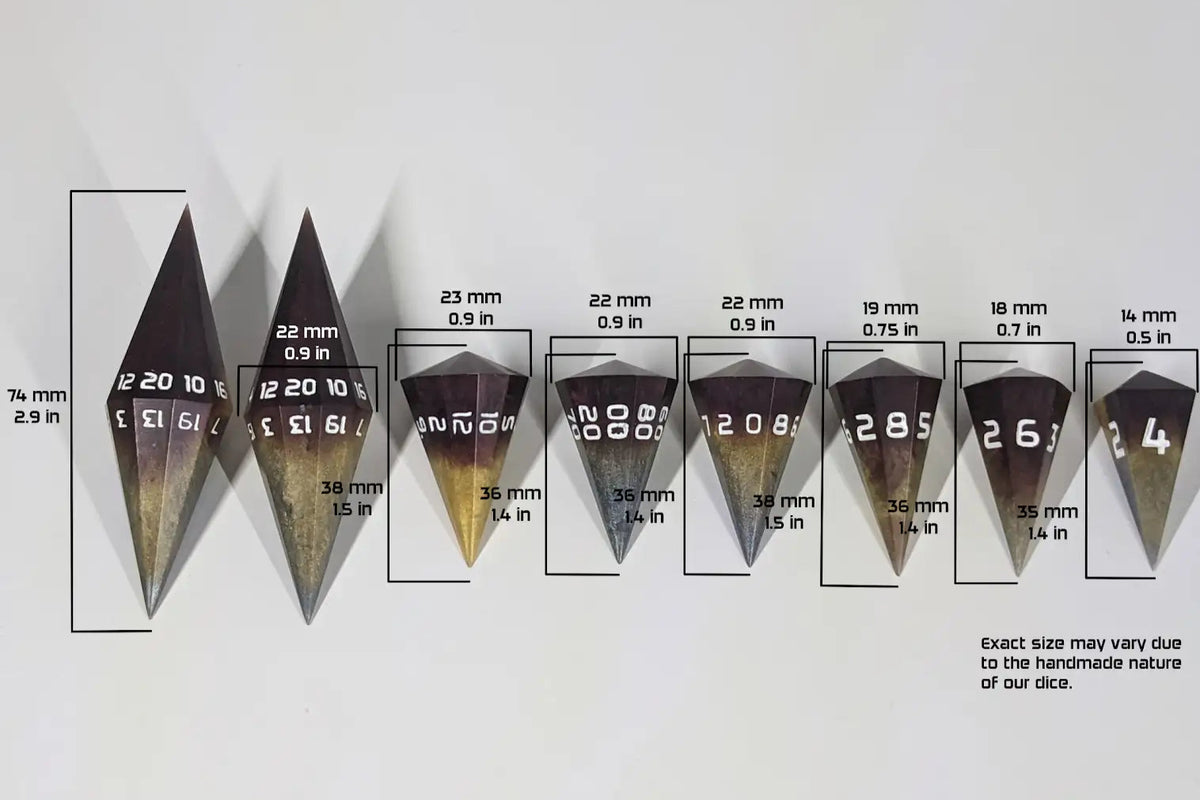 A size graphic of dagger dice. It shows the d20 as 74mm 2.9in tall and the second d20 shows the width as 22mm 0.9in. The d12 is 38mm 1.5in long & 23mm 0.9in wide; the d% is 36mm 1.4in long & 22mm 0.09in wide; the d10 is 36mm 1.4in long & 22mm 0.09in wide; the d8 is 38mm 1.5in long & 19mm 0.75in wide; the d6 is 36mm 1.4in long & 18mm 0.7in wide; the d4 is 35mm 1.4in long & 14mm 0.5in wide. The bottom right corner has a note “Exact size may vary due to the handmade nature of our dice.”