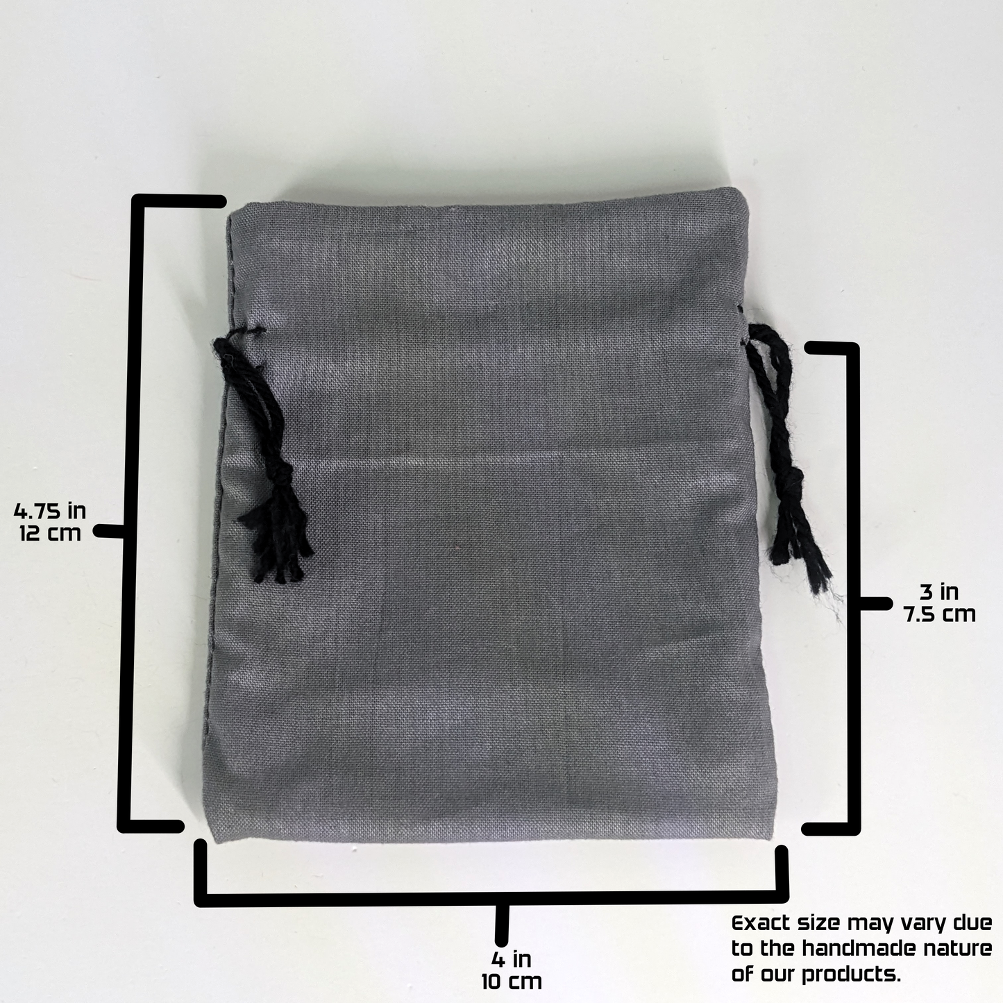 A handmade, gray, small size dice bag with black drawstrings lays flat on a white background. The graphic includes overlays showing the full height of the dice bag as 4.75 inches or 12 cm, the width of the dice bag as 4 inches or 10 cm, and the height from bottom to drawstring as 3 inches or 7.5 cm. A note in the bottom right corner states "Exact size my vary due to the handmade nature of our products."