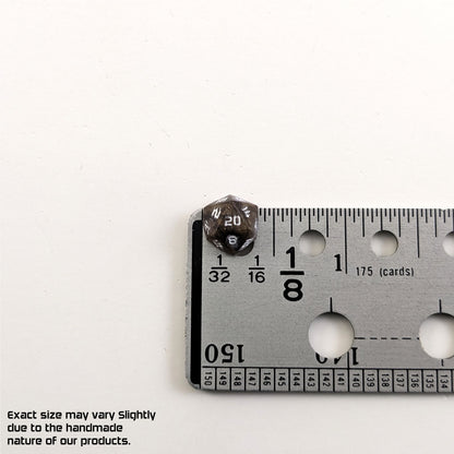 A size graphic of the d20 stud. The stud is brown with white numbers and centers the 20 face next to a ruler on a white background. The ruler shows the width of the stud as 10 mm or 0.39 in. The lower lefthand corner has a disclaimer that reads, "Exact size may vary slightly due to the handmade nature of our products."