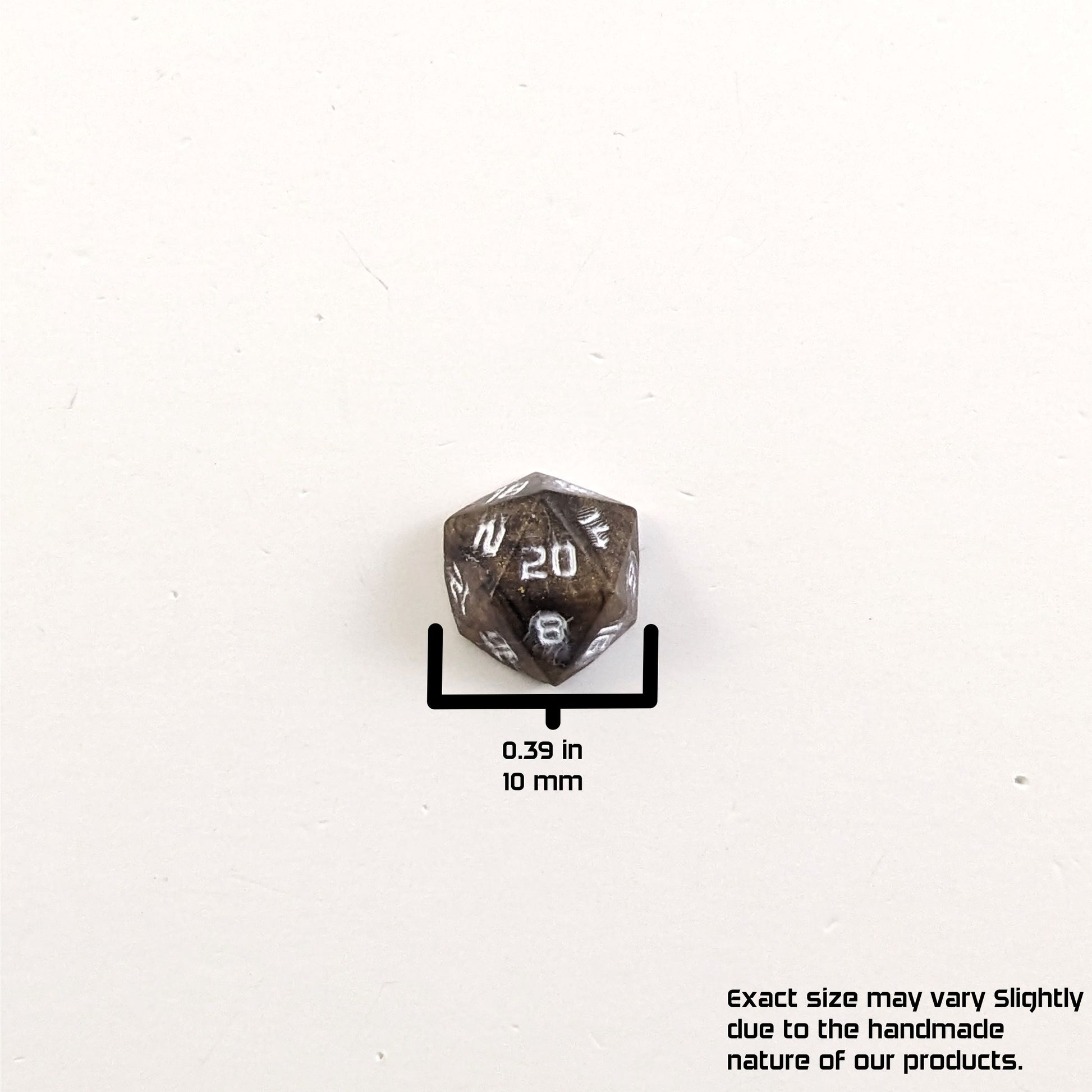A size graphic of the d20 stud. The stud is brown with white numbers and centers the 20 face on a white background. The graphic overlay shows the width of the stud as 10 mm or 0.39 in. The lower righthand corner has a disclaimer that reads, "Exact size may vary slightly due to the handmade nature of our products."