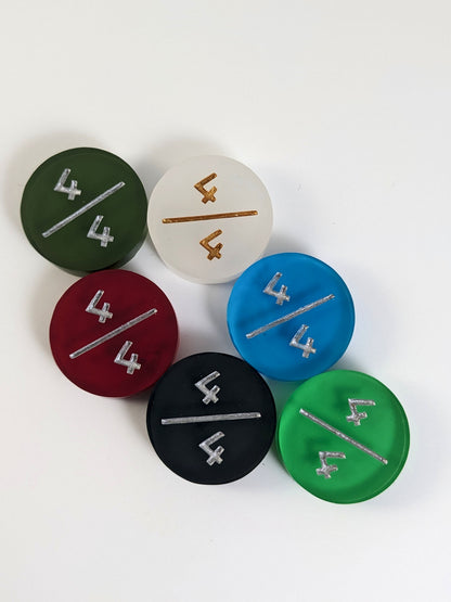 A collection of 4/4 tokens in a variety of colors on a white background. Each token is face up.