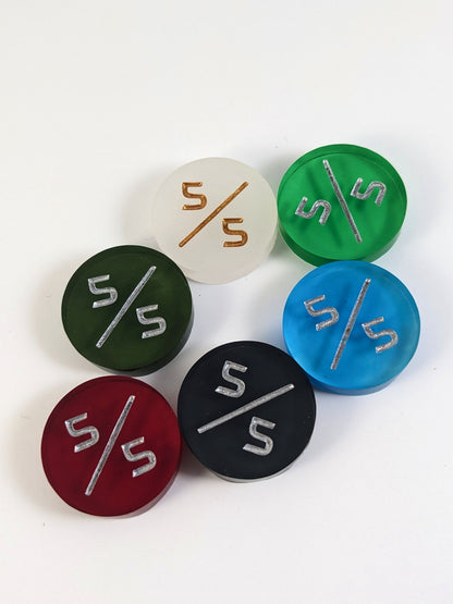 A collection of 4/4 tokens in a variety of colors on a white background. Each token is face up.