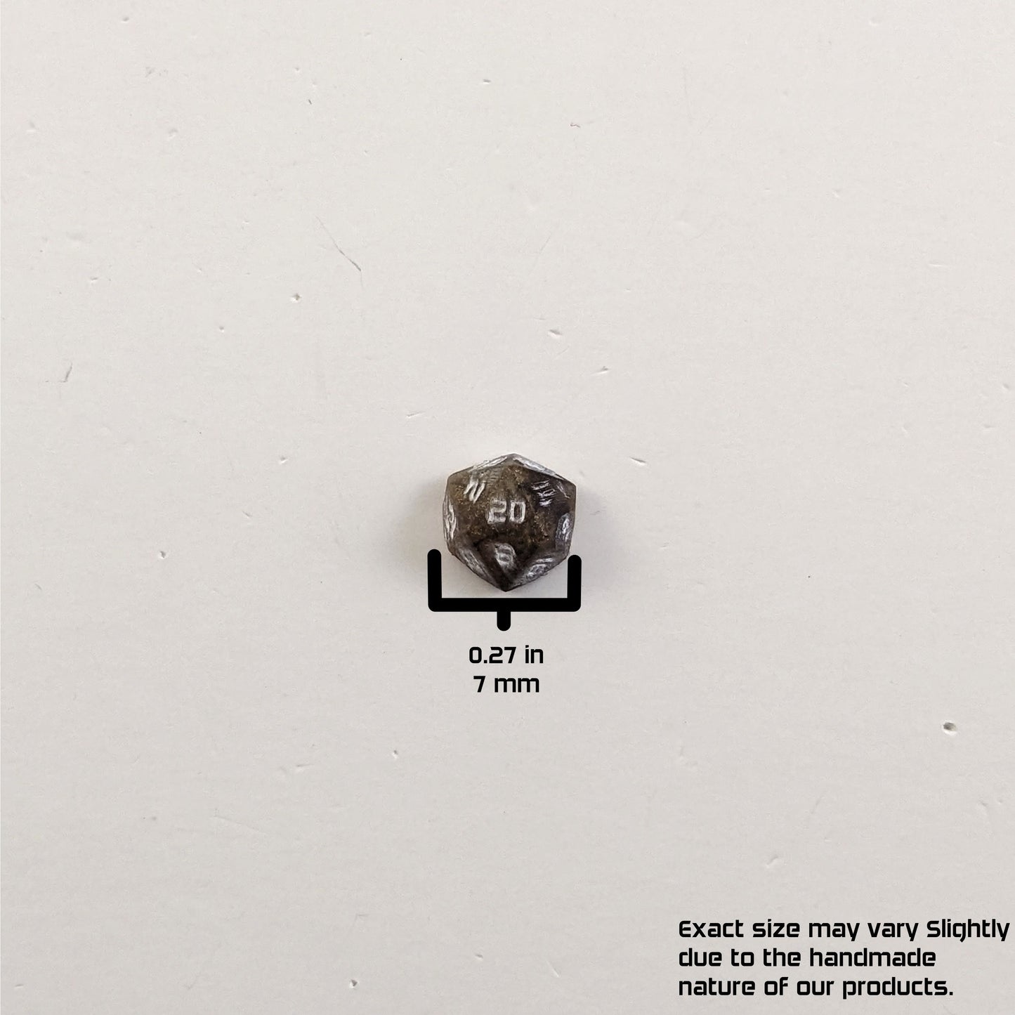 A size graphic of the d20 stud. The stud is brown with white numbers and centers the 20 face on a white background. The graphic overlay shows the width of the stud as 7 mm or 0.27 in. The lower righthand corner has a disclaimer that reads, "Exact size may vary slightly due to the handmade nature of our products."