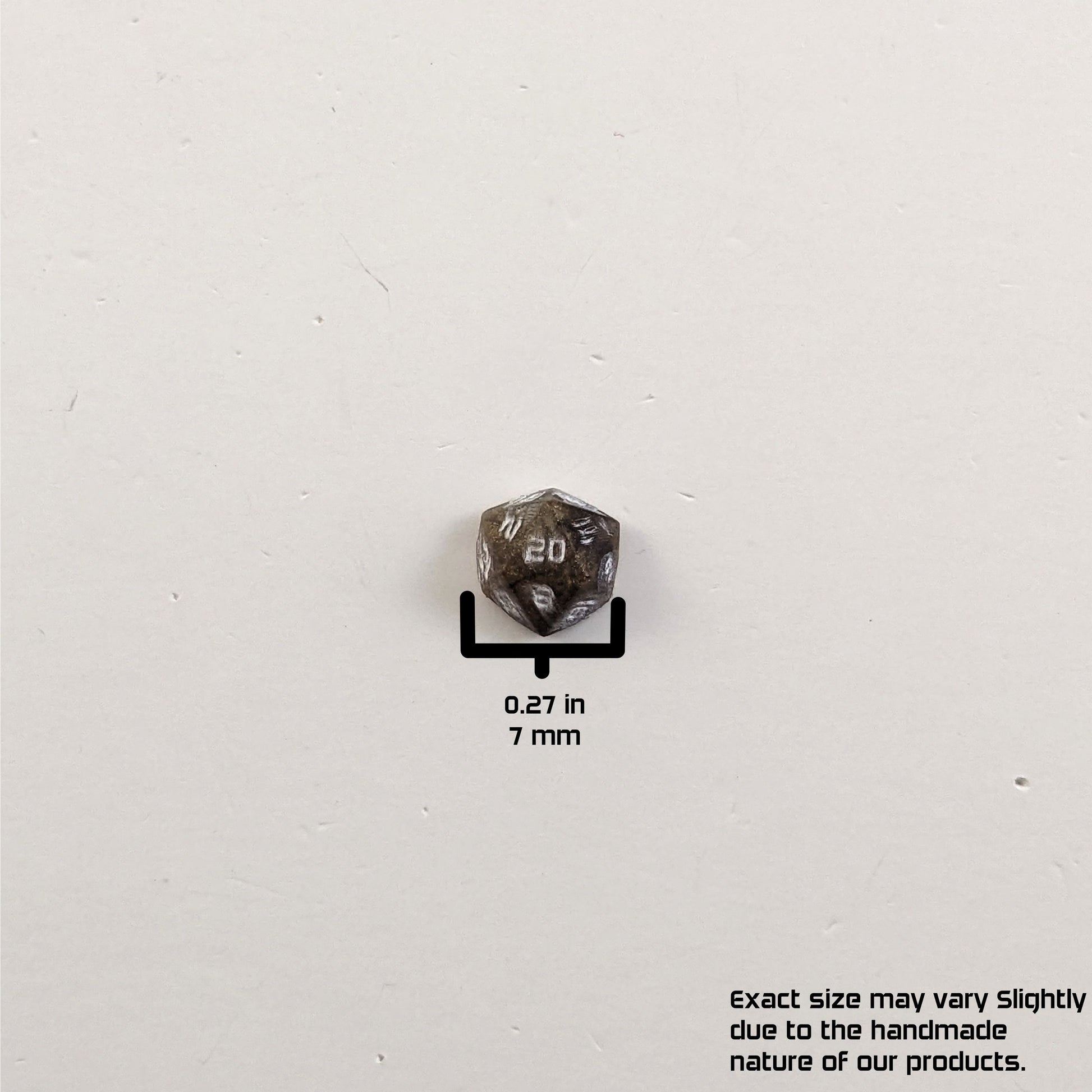 A size graphic of the d20 stud. The stud is brown with white numbers and centers the 20 face on a white background. The graphic overlay shows the width of the stud as 7 mm or 0.27 in. The lower righthand corner has a disclaimer that reads, "Exact size may vary slightly due to the handmade nature of our products."
