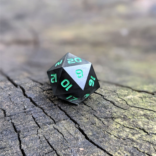 A standard d20 with black swirls and green numbers sits on a wood stump with the 20 face up.