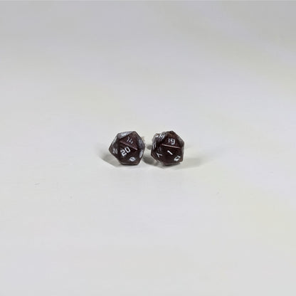 A single pair of the smaller size handmade d20 earrings with sterling silver hardware that are maroon and silver with white numbers on a white background. The earring on the left centers the 20 face and the earring on the right centers the 1 face.