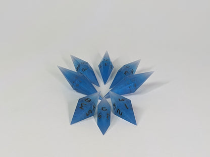 A complete set of resin dice featuring 2 d20s for advantage rolls. These electric blue swirls with grey numbering slender handmade diamond dice are clustered in a tight circle on a white background, highlighting the quality of the artisan dice craftsmanship and the unique pointed shape.