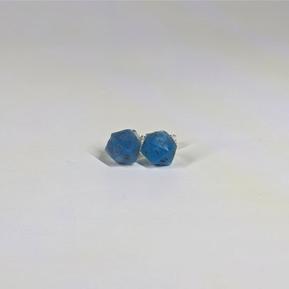 A single pair of the smaller size handmade d20 earrings with sterling silver hardware that are swirls of blue with stormy gray numbers on a white background. The earring on the left centers the 20 face and the earring on the right centers the 1 face.