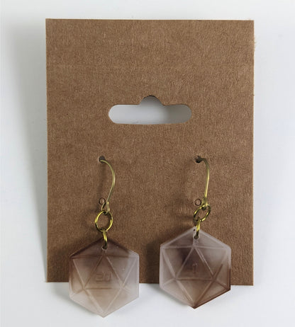 A pair of espresso brown and white dangly, flat d20 earrings with gold color titanium and niobium hardware on a kraft earring card on a white background. The earring on the left has a 20 on it and the earring on the right has a 1 on it, both in a sci-fi style font.
