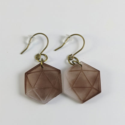 A pair of espresso brown and white dangly, flat d20 earrings with gold color titanium and niobium hardware and bell shaped rubber backs on a white background.