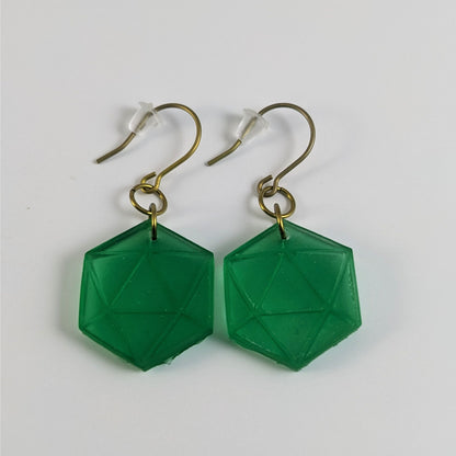 A pair of emerald green dangly, flat d20 earrings with gold color titanium and niobium hardware and bell shaped rubber backs on a white background.