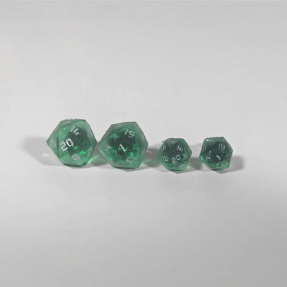 Two pairs of handmade d20 earrings with titanium hardware that are emerald green with silver numbers on a white background sit in a line with the larger pair on the left and the smaller pair on the right. The earrings on the left of each pair centers the 20 face and the earrings on the right of each pair centers the 1 face.
