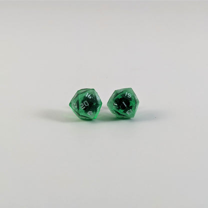 A single pair of the larger size handmade d20 earrings with titanium hardware that are emerald green with silver numbers on a white background. The earring on the left centers the 20 face and the earring on the right centers the 1 face.