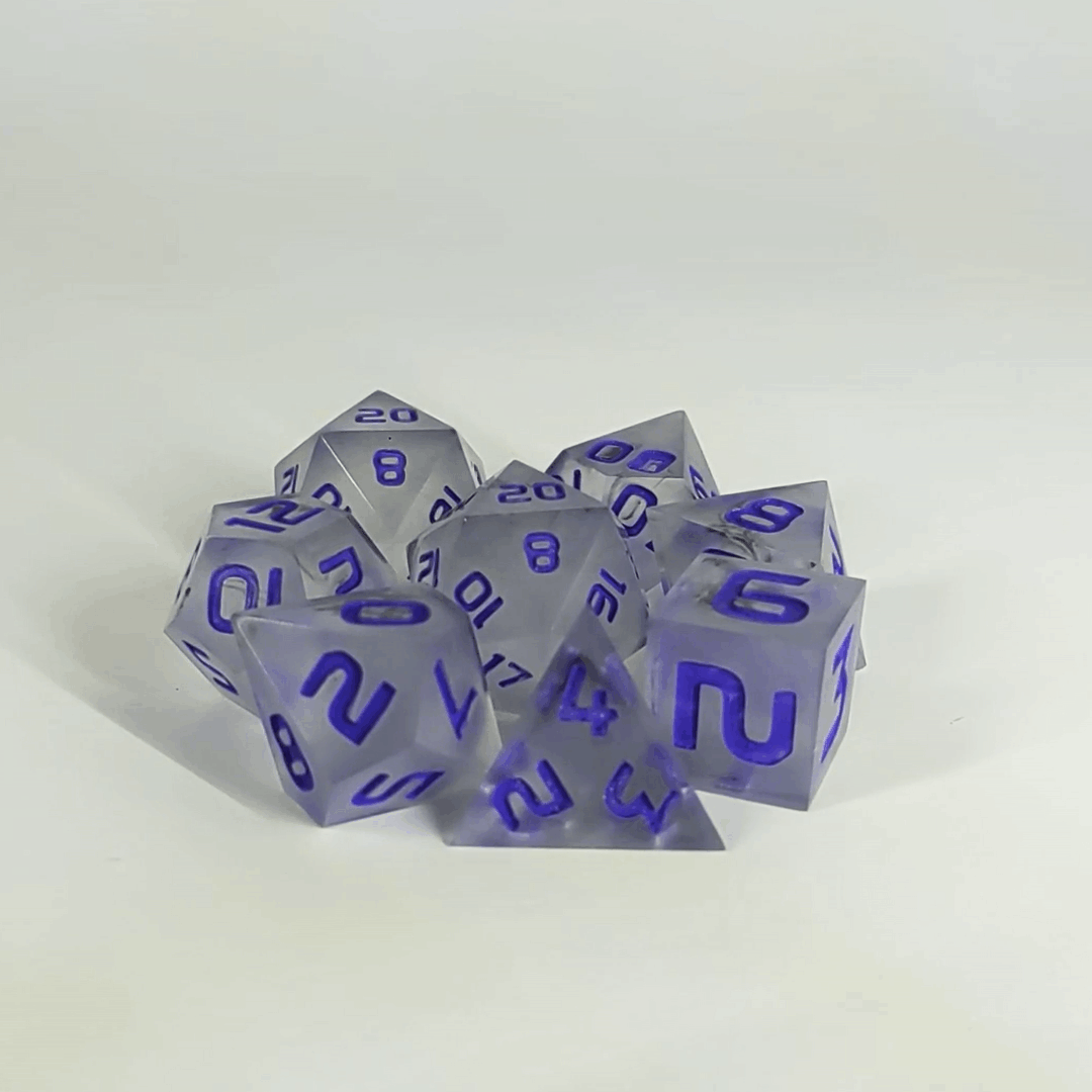 A gif showing the polyhedral dnd dice in a circle with a d20 in the middle surrounded by a standard 7 dice set. The dice have black swirls and purple numbers. The gif transitions from light to darkness and the dice shift from their normal color to the inserts glowing green in the dark.
