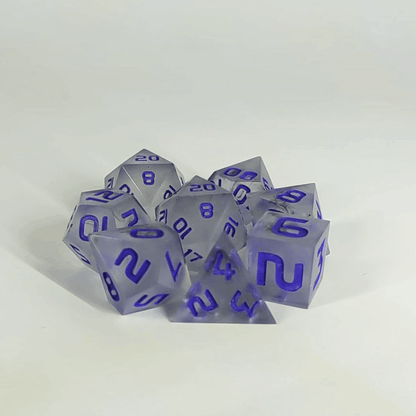 A gif showing the polyhedral dnd dice in a circle with a d20 in the middle surrounded by a standard 7 dice set. The dice have black swirls and purple numbers. The gif transitions from light to darkness and the dice shift from their normal color to the inserts glowing green in the dark.