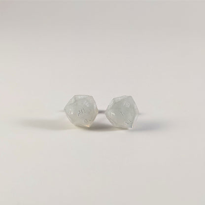 A single pair of the larger size handmade d20 earrings that are frosty white with white numbers on a white background. The earring on the left centers the 20 face and the earring on the right centers the 1 face.