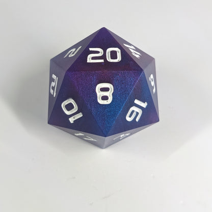 A large d20 that has subtle swirls of purple, blue, and pink with white numbers sits in front of a white background.