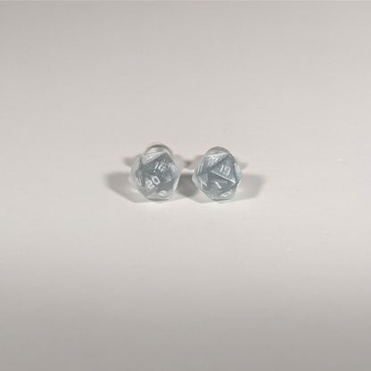A single pair of the smaller size handmade d20 earrings with titanium hardware that are frosty blue and white with white numbers on a white background. The earring on the left centers the 20 face and the earring on the right centers the 1 face.