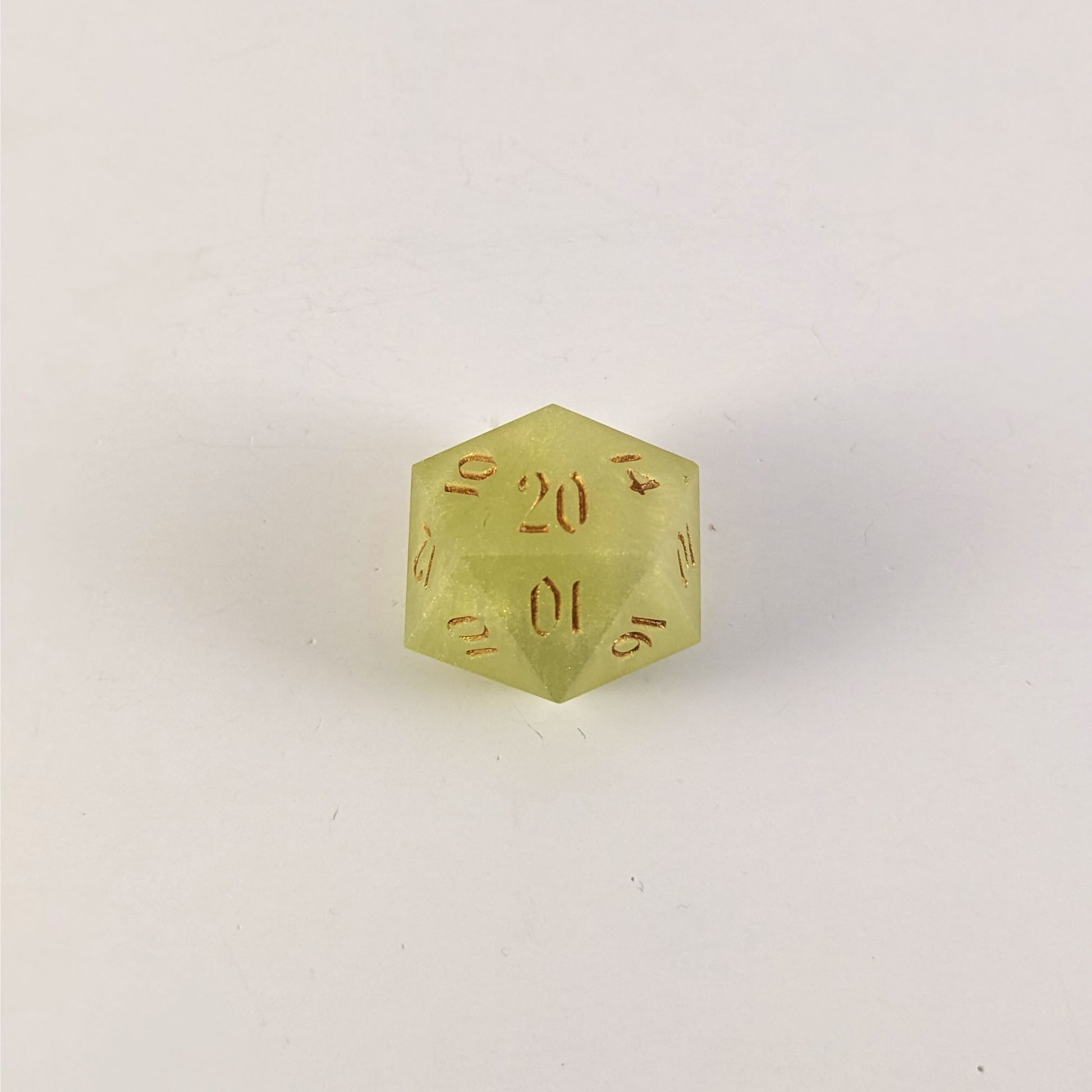 A top down photo of a reliable talent d20 on a white background. The die is light green with gold numbers. Faces that would be 9 or below are replaced with a 10.