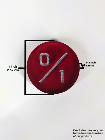 A top down photo of a red 0/1 token with a graphic overlay showing the size. The overlay shows the diameter of the token as 1 inch or 1.54 cm and the depth of the token as 1/4 inch or 6.35 mm. The bottom right of the image has a text disclaimer that reads, "Exact size may vary due to the handmade nature of our products."