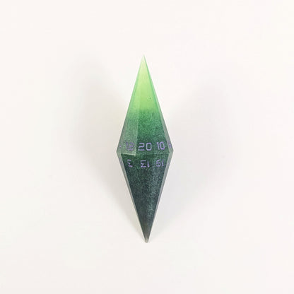 A high angle view of a diamond d20 with swirls of black and green with purple numbers that glow in the dark on a white background.