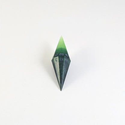 A mid angle view of a diamond d20 with swirls of black and green with purple numbers that glow in the dark on a white background.