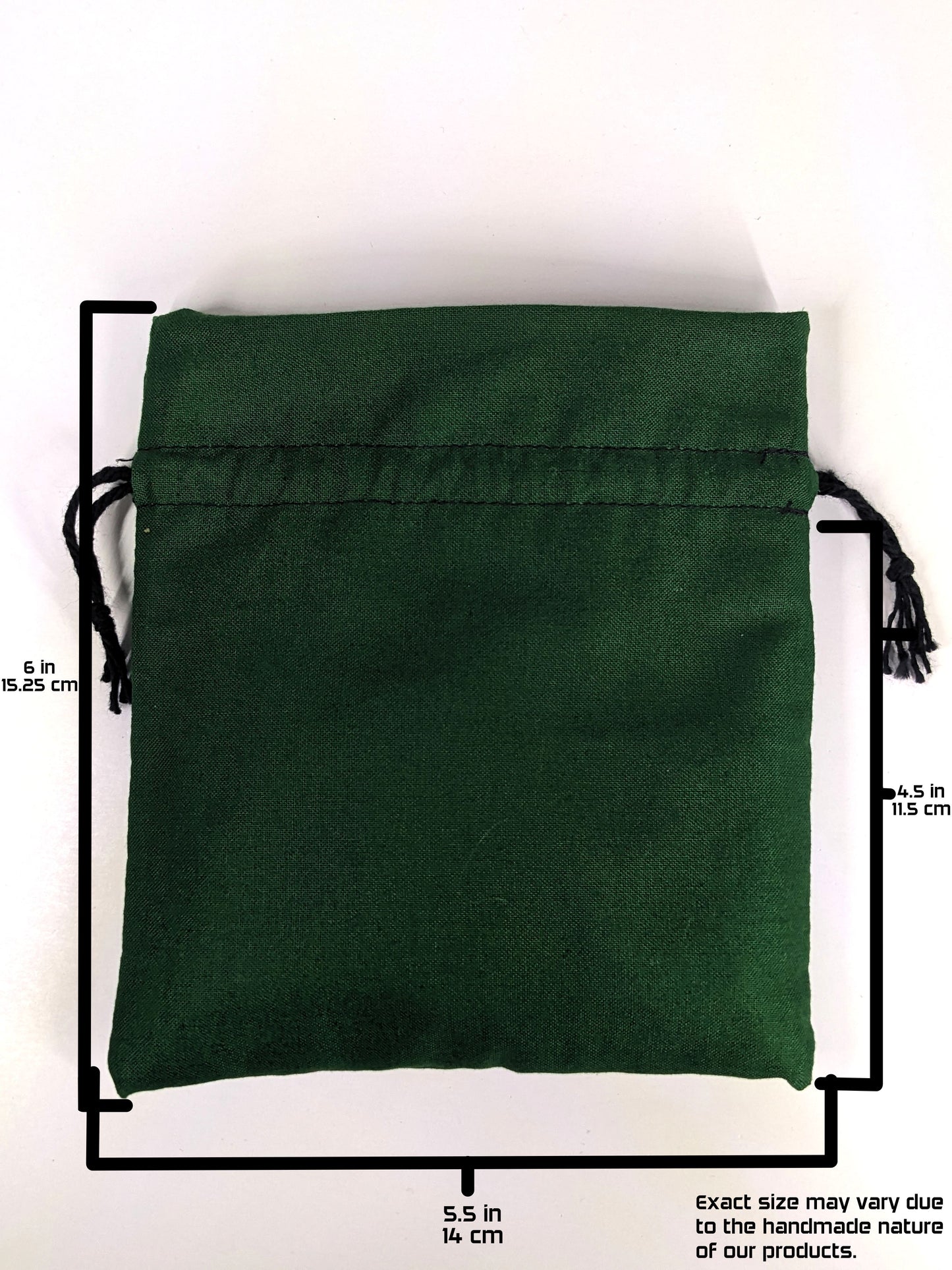 A handmade, dark green, medium size dice bag with black drawstrings lays flat on a white background. The graphic includes overlays showing the full height of the dice bag as 6 inches or 15.25 cm, the width of the dice bag as 5.5 inches or 14 cm, and the height from bottom to drawstring as 4.5 inches or 11.5 cm. A note in the bottom right corner states "Exact size my vary due to the handmade nature of our products."
