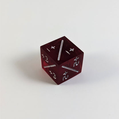 A mid angle photo of a red positive counter d6 with silver numbers sits on a white background with the corner of the +1/+1, +2/+2, and +3/+3 faces angled toward the camera.