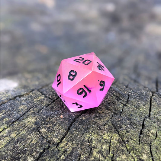 A standard d20 with pink/purple swirls and black numbers sits on a wood stump with the 20 face up.