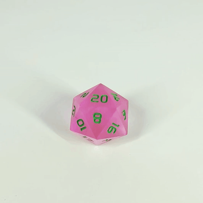A high angle gif of a standard d20 with pink/purple swirls and green numbers with the 20 face up on a white background. The image shifts from regular light to darkness, where the die starts to glow green.