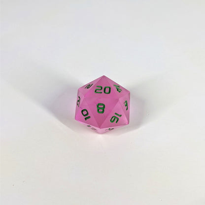 A high angle photo of a standard d20 with pink/purple swirls and green numbers with the 20 face up on a white background.