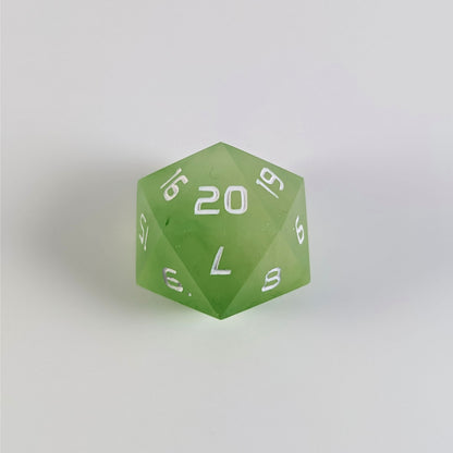 A yellow green spindown d20 with white numbers and a right spin sits on a white background with the 20 face up.