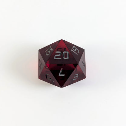 A red spindown d20 with gray numbers and a right spin sits on a white background with the 20 face up.