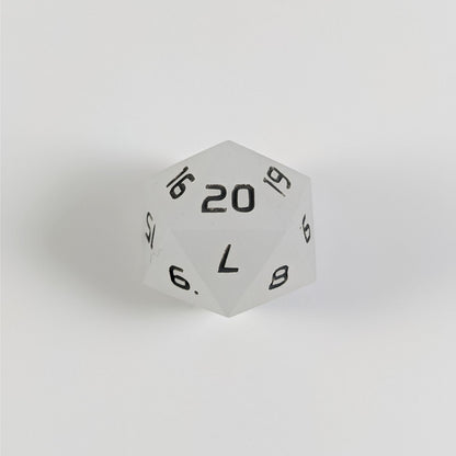A white spindown d20 with gray numbers and a right spin sits on a white background with the 20 face up.