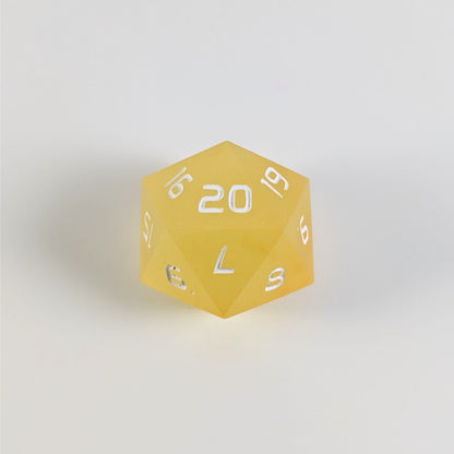 A yellow spindown d20 with white numbers and a right spin sits on a white background with the 20 face up.