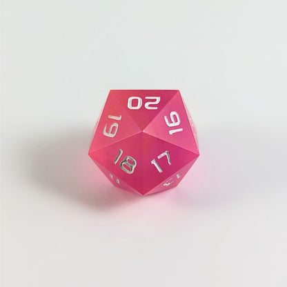 A low angle of a magenta spindown d20 with white numbers and a right spin sits on a white background with the 20 through 16 corner facing the camera showing the spiral of the spin down.