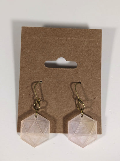 A pair of pale pink and white dangly, flat d20 earrings with gold color titanium and niobium hardware on a kraft earring card on a white background.