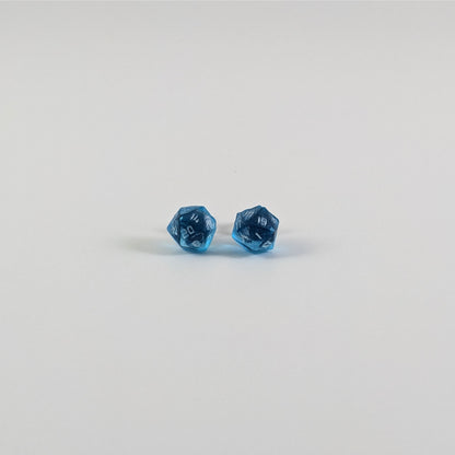 A single pair of the smaller size handmade d20 earrings with titanium hardware that are sapphire blue with silver numbers on a white background. The earring on the left centers the 20 face and the earring on the right centers the 1 face.