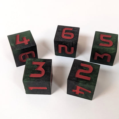 Five standard six sided dice sit on a white background. The dice are black and dark green with red numbers. Going clockwise starting in the upper left corner the dice have 4, 6, 5, 3, and 2 face up.