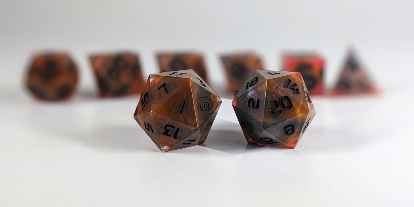 A straight on photo of a standard set of DnD dice that are a glowy red-orange with dark spherical inserts and black numbers focusing on 2 d20s in the center. The d20 on the left has the 1 face centered and the d20 on the right has the 20 face centered. The other 6 dice are lined up in the background but are out of focus, while the d20s are in sharp focus.