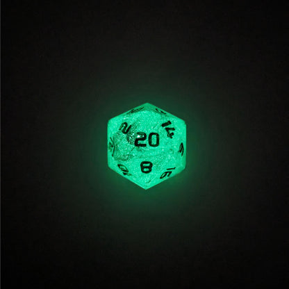 A high angle photo of a standard d20 glowing green with black swirls and green numbers with the 20 face up on a white background.