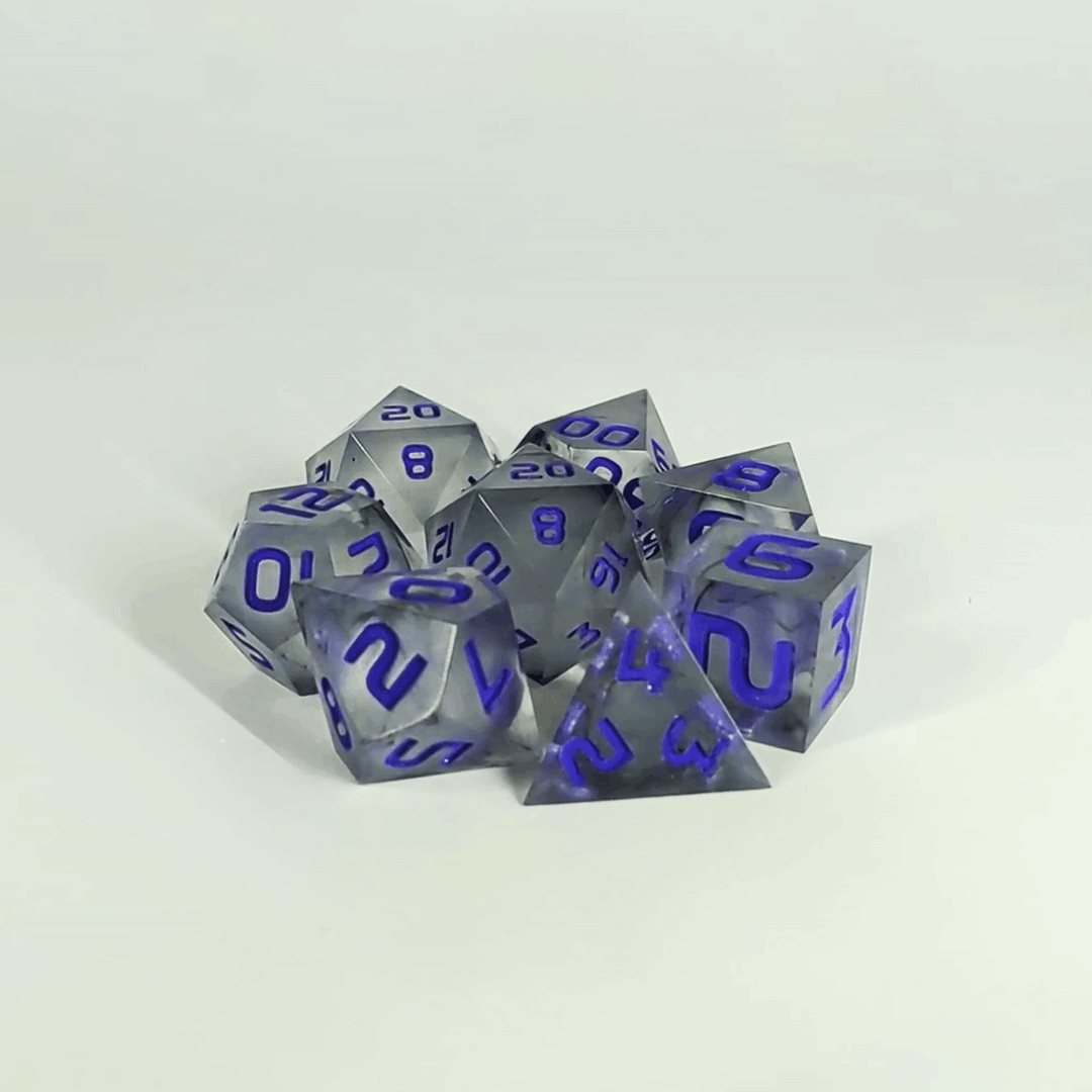 A gif showing the polyhedral dnd dice in a circle with a d20 in the middle surrounded by a standard 7 dice set. The dice have black swirls and purple numbers. The gif transitions from light to darkness and the dice shift from their normal color to the spherical inserts glowing green in the dark.