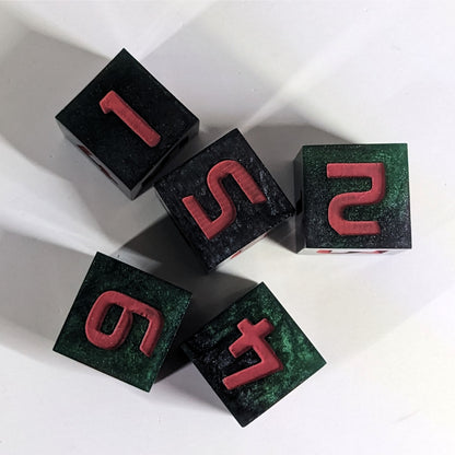 A top down view of 5 d6s on a white background. The dice are black and dark green with red numbers. The face up numbers are 1, 5, 2, 4, and 6.