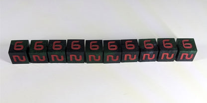 Ten standard d6s are arranged in a line on a white background. The dice are dark green and black and have red numbers. All of the dice have the 6 face up.