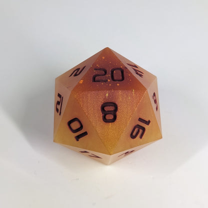 A large d20 that has swirls of orange, yellow, and a small amount of red with dark red numbers sits in front of a white background.