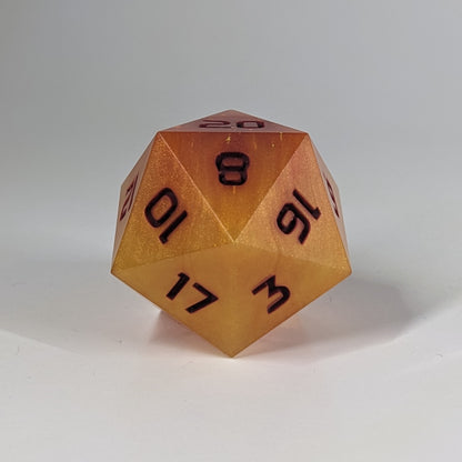 A straight on photo of a large d20 that has swirls of orange, yellow, and a small amount of red with dark red numbers on a white background.