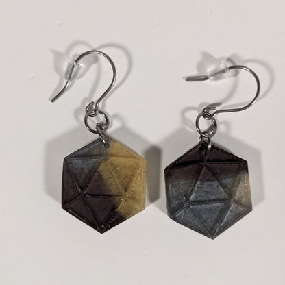 A pair of gold, maroon, and dark silver dangly, flat d20 earrings with silver color titanium and niobium hardware and bell shaped rubber backs on a white background.