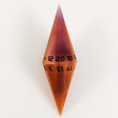 A high angle shot of a purple and orange dagger d20 with black numbers on a white background.