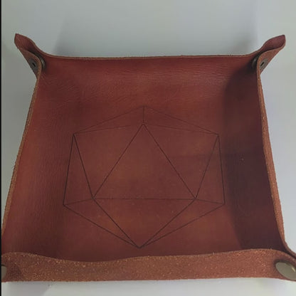 The video starts with a brown leather dice tray in view that has a d20 shape lasered into it. A hand appears from the bottom right corner holding a complete set of polyhedral dice that are  blue with red flakies and white numbers. The hand rolls all of the dice into the tray from the right.